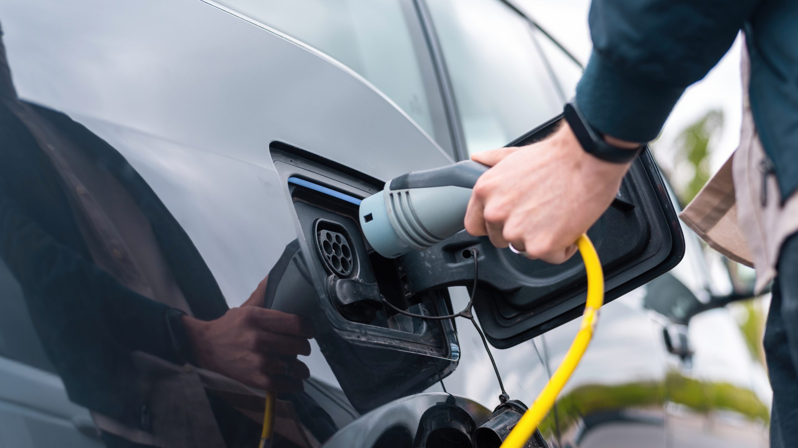 Man charging electric car